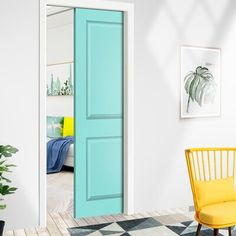 a room with a blue door, yellow chair and potted plant on the floor