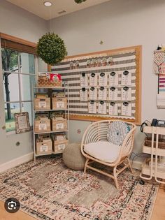 a room with a chair, rug and shelves filled with boxes on the wall next to a window