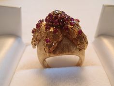 This is an incredible handmade 18 karat yellow gold ruby & diamond ring from Italy. Doubtful I will ever find another one like it, in my lifetime. It's a starfish encrusted on a dome, with 34 all natural pigeon-blood rubies, total weight approx. .33 ct, and a natural diamond, approx. .06 carat, VS1 and G-H color that measures 3mm across. Its Florentine detail is superb. The top of the dome measures 20.84 mm and tapers to a 2.73 mm shank. Stamped 18K and ITALY. Also there's a designer's mark. Unique Yellow Gold Ruby Ring, Ruby Diamond Ring, Ruby Diamond Rings, Retro Ring, Ruby Diamond, Pandora Bracelet, Pigeon, Starfish, Charm Pendant