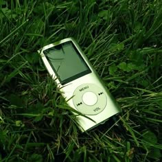 an mp3 player laying in the grass on top of it's side