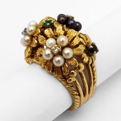 "Vintage 18 K (.750) yellow gold cocktail ring in floral designs, decorated with Seed Pearls, Emerald, Ruby, Sapphire and Diamonds. This fabulous ring is a size 7, 11/16\" wide and weighs 14.6 grams. EA1065" Amethyst Cocktail Ring, Yellow Gold Cocktail Ring, Floral Cocktails, Coral Flowers, Gold Cocktail Ring, Star Pendant Necklace, Gold Cocktail, Ruby Sapphire, Seed Pearl