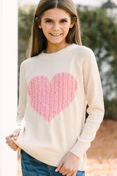 This sweater is here for all of your love! That knit heart is so cute! This sweater is absolutely perfect for Valentine's Day but we think it will also be perfect for any day of the week! Round neckline Long sleeves Cable knit heart Generous... Pink Heart Sweater, Cute Heart Pattern, Knit Heart, All For Love, Spring Cardigans, Knitted Heart, Heart Sweater, Cute Heart, Casual Design