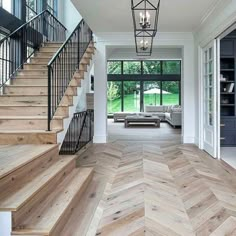 an open floor plan with wood floors and stairs