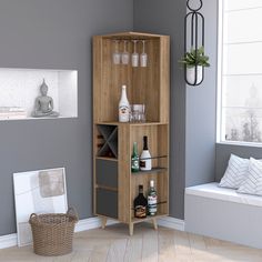 a wooden cabinet with bottles and glasses on it in a room next to a window