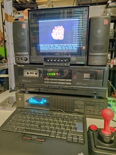 a laptop computer sitting on top of a desk next to an old fashioned stereo system