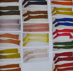 an assortment of different colored socks laid out in rows