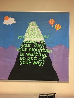 a bulletin board hanging on the wall above a keyboard