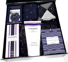 an open box containing men's personal care items, including socks and socks in it