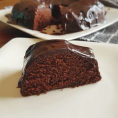 there is a piece of chocolate cake on the plate and one slice has been eaten