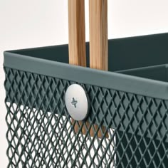 a close up of a metal basket with wood handles