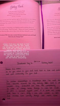 two pink books with writing on them