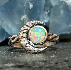 Crescent moon opal ring in solid sterling silver with a Celtic knot band. This ring is made to order in your size. The stone measures 6mm in size and the moon in 12mm. These are man made opals and they are absolutely stunning. Custom orders are welcome. Feel free to contact me with questions or comments.  Ring size. Made to order in your size. Silver Celestial Opal Promise Ring, Mystical Sterling Silver Opal Promise Ring, Silver Sterling Silver Moon Shaped Opal Ring, Handmade Celestial Silver Opal Ring, Silver Moonstone Ring With Ethiopian Opal, Unique Nickel-free Round Opal Ring, Celestial Silver Opal Ring, Mystical Silver Opal Ring, Handmade Celestial Opal Ring