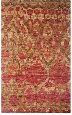 an old rug with red and brown colors