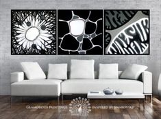 three black and white paintings in a living room