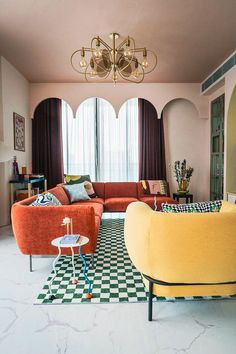 a living room filled with furniture and a chandelier