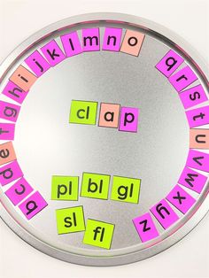 a circular mirror with words that spell out the word clacks in pink, orange and yellow