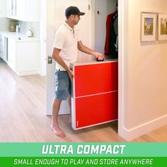 a man standing next to a red cabinet in a white room with the words ultra compact small enough to play and store anywhere