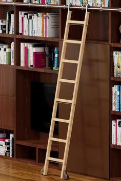 a ladder leaning against a bookshelf in front of a bookcase full of books