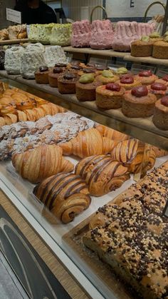 a display case filled with lots of different types of pastries