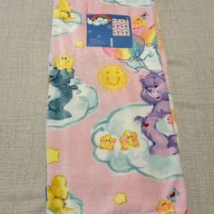 a pink blanket with bears and clouds on it