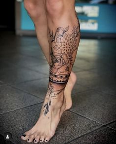 a woman's legs with tattoos on them