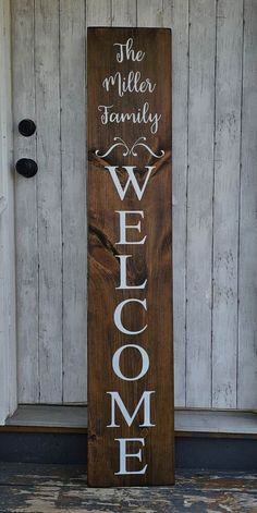 a wooden welcome sign sitting on top of a door