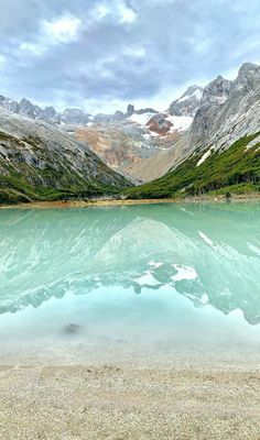 a mountain lake surrounded by snow covered mountains