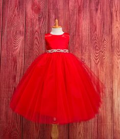 Red 4 Layer Tulle-Ankle Length Dress  This classic beautiful, elegant dress is one of my favorite! So modern and classy for any special occasion. The bodice is made of Red bridal satin, a hidden zipper can be found on the back of the dress, followed by an elegant rhinestone band at the waistline (not removable) The skirt consist of 4 Red Tulle layers and two layers of lining followed by crinoline for a fuller look. If you are interested in a specific color to match your color scheme please message me! Dress is pictured with Petticoat to show full detail. NOT INCLUDED https://www.etsy.com/listing/1305138635/white-ankle-length-petticoat-wedding?click_key=79499b8045349abec4d15e286ce2a8958c22127e%3A1305138635&click_sum=143c4c83&ref=shop_home_active_2&sts=1 Visit our store, more items to come! Elegant Christmas Tulle Tutu Dress, Elegant Christmas Tutu Dress In Tulle, Elegant Tulle Ball Gown For Christmas, Elegant Christmas Tulle Ball Gown, Holiday Wedding Tulle Princess Dress, Elegant Christmas Ball Gown, Elegant Tutu Dress For Holiday Pageants, Elegant Holiday Tutu Dress For Pageant, Elegant Red Princess Dress For Formal Occasions