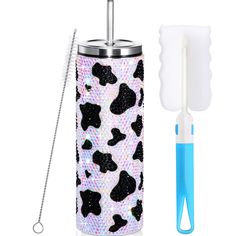 the toothbrush holder is decorated with black and white leopard print, along with a straw