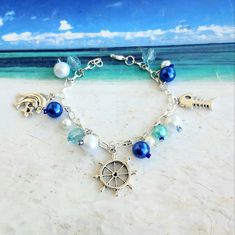 Handmade Dangle Bracelets For Beach, Silver Strand Bracelets As Gift, Summer Gift Bracelets With Pearl Charm, Handmade Nautical Style Bracelets For Beach, Handmade Silver Bracelets For Beach Season, Summer Pearl Charm Bracelets As Gifts, Silver Bracelet For Beach Season Gift, Summer Pearl Charm Bracelet Gift, Personalized Blue Bracelets For The Beach