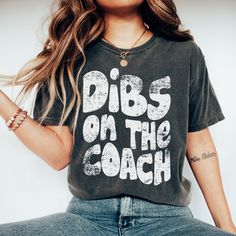 Show your love of the game and the coach with this vintage style design on the popular comfort colors tee. This is a fun shirt for the game and everyday wear! It Makes the perfect gift or shirt for the coach's wife! This garment-dyed t-shirt is made with 100% ring-spun cotton. The soft-washed, garment-dyed fabric brings extra coziness to your wardrobe while the relaxed fit makes it an excellent daily choice. The double-needle stitching throughout the tee makes it highly durable while the lack of Coaches Wife Shirt, Coaches Wife, Coach Shirts, School Spirit Shirts, Football Mom Shirts, Spirit Shirts, Shirt Football, Game Day Shirts, Spirit Wear