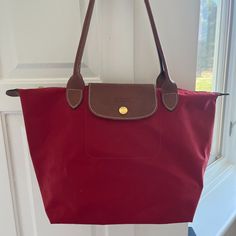 Red Longchamp Le Pliage Bag, Overall In Good Condition, No Signs Of Damage Or Wear. Classic Red Shoulder Bag With Leather Handles, Classic Red Bags With Leather Handles, Red Tote Shoulder Bag With Snap Closure, Red Shopping Bag With Snap Closure, Red Bags With Snap Closure For Shopping, Classic Red Shoulder Bag For Travel, Everyday Red Shoulder Bag With Snap Closure, Red Shoulder Bag With Snap Closure For Everyday, Everyday Red Bag With Snap Closure