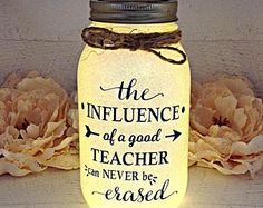 a mason jar with the words, the influence of a good teacher can never be passed