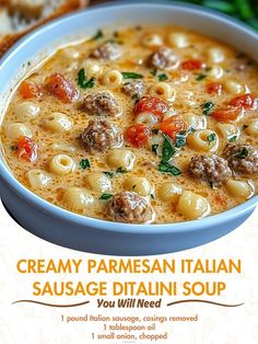 a bowl of creamy parmesan italian sausage and pasta soup with bread on the side