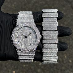 Step into elegance with this fully iced-out diamond watch and staggered bracelet set that mirrors genuine luxury watches. We utilize premium simulated diamonds crafted from high-refractive crystals, ensuring a sparkle that rivals authentic diamonds under the light! INCLUDES AN EASY-TO-USE SIZE ADJUSTMENT TOOL Specifications: - Gender: Men's - Case Size: 46mm - Sizing: 8.5-inch band - Bracelet Length: 9-inches (Non-adjustable) - Movement: Quartz Movement - Battery: Included - Adjustable: Watch Li Silver Diamond Watch With Cubic Zirconia For Parties, Silver Cubic Zirconia Diamond Watch For Party, Diamond Watch With Rhinestones For Party, Silver Diamond Watch With Bling, Silver Diamond Watch Iced Out For Party, Silver Diamond Watch With Crystal For Parties, Silver Diamond Watch With Rhinestones And Crystal, Silver Crystal Diamond Watch For Parties, Silver Watch With Rhinestones And Cubic Zirconia