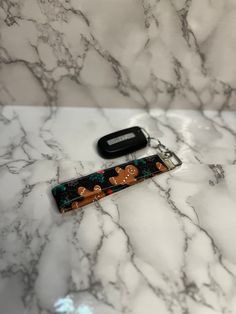 a pair of scissors sitting on top of a white marble counter next to a cell phone