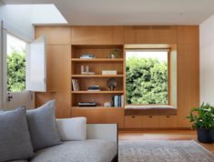 a living room filled with furniture next to a window covered in lots of windowsills