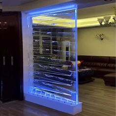 a large display case in the middle of a living room filled with furniture and lighting