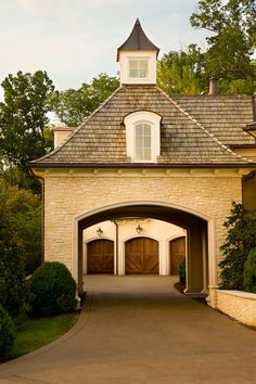 a driveway leading to a large brick house