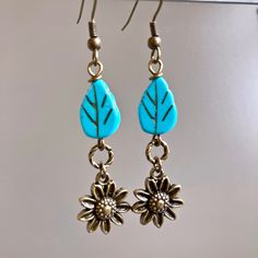 "Sunflower Earrings - Brass plated Sunflowers dangle from Turquoise Czech Glass Leaf Beads and Twisted Antiqued Brass plated Rings. Antiqued Brass Earwires Earrings measure j2.25\" from top of earwire to bottom of flowers." Gift For Gardener, Leaf Beads, Earrings Nature, Sunflower Earrings, Daisy Earrings, Earrings Flower, Garden Jewelry, Natural Gifts, Earrings Boho