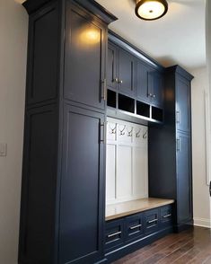 a room that has some cabinets and drawers in it with lights on the wall above them