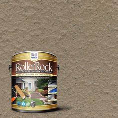 a paint can sitting on the ground next to a white house with a brown roof