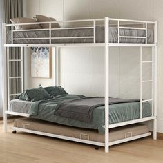 a white bunk bed sitting on top of a hard wood floor