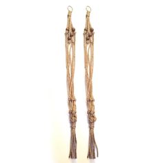 two pairs of earrings are shown against a white background, one is made out of rope and the other has long tassels