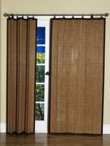 an open window with brown curtains in front of it and a wooden floor next to it