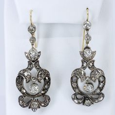 "Georgian silver topped 14k gold drop earrings with over 5 carats of diamonds feature a combination of old mine cut and rose cuts. The stunning earrings have been preserved for nearly 200 years. One has been repaired at some point in its history of ownership. The bottom flourish was reattached and the top of the pendulous was reinforced and reattached. See detailed imagery of repairs. These have not been cleaned by us in case of foil backings on non open backed stone mountings, which were preval Formal Rose Cut Diamond Chandelier Earrings, Formal Chandelier Earrings With Rose Cut Diamonds, Luxury Rose Cut Drop Diamond Earrings, Elegant Chandelier Earrings With Rose Cut Diamonds, Classic Rose Cut Diamond Earrings For Evening, Elegant Rose Cut Diamond Drop Earrings, Victorian Yellow Gold Earrings With Single Cut Diamonds, Antique Diamond Wedding Earrings, Vintage Rose Cut Diamond Earrings For Formal Occasions