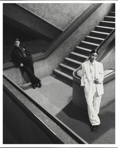 black and white photograph of two men in suits on stairs