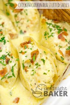 chicken and cheese stuffed shells in a casserole dish with parsley on top