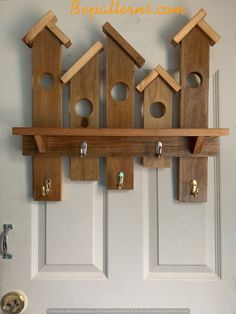 wooden bird houses are hanging on the wall