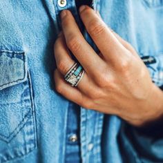 a person wearing two rings on their fingers and one ring is in the other hand